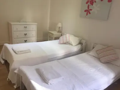 a bedroom with two beds with white sheets and a dresser at Nice - Paillon apartment by Stay in the heart of ... in Nice