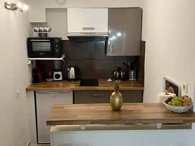 a kitchen with a table with a bowl of fruit at Appartement 2 pièces Nice in Nice