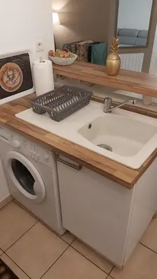 a kitchen counter with a sink and a washing machine at Appartement 2 pièces Nice in Nice