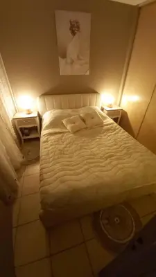 a bedroom with a white bed with two night stands at Appartement 2 pièces Nice in Nice