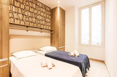 two beds in a small room with a window at MASSENA AP4312 By Riviera Holiday Homes in Nice
