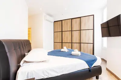 a bedroom with a bed with two towels on it at MASSENA AP4312 By Riviera Holiday Homes in Nice