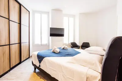a bedroom with a large bed with towels on it at MASSENA AP4312 By Riviera Holiday Homes in Nice
