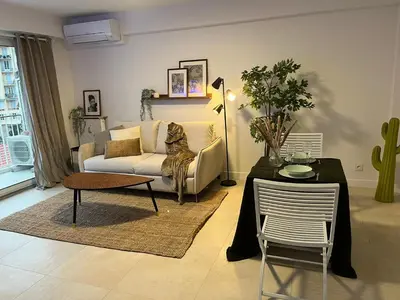 a living room with a couch and a table at PALAIS ROYAL - Appartement tout confort in Nice