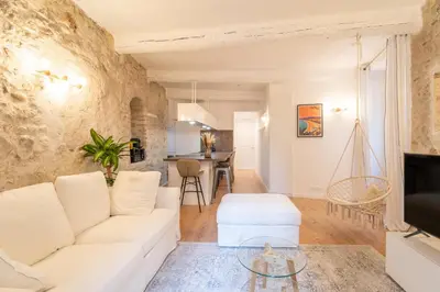 a living room with a white couch and a table at Old Town Nice Renovated 2BR Near Beaches & Cours Saleya in Nice
