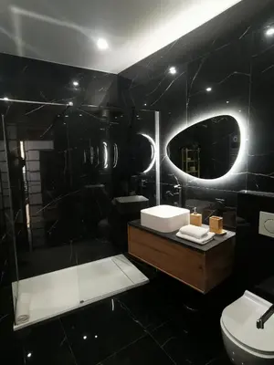a black bathroom with a sink and a mirror at Proche mer, vieille ville. Luxueux appartement in Villefranche-sur-Mer