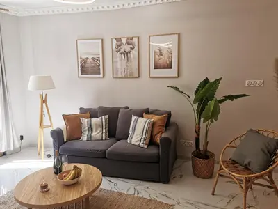 a living room with a couch and a table at Proche mer, vieille ville. Luxueux appartement in Villefranche-sur-Mer