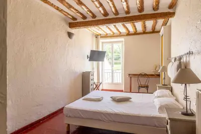 a bedroom with a bed and a large window at Appartements Vivo in Cagnes-sur-Mer