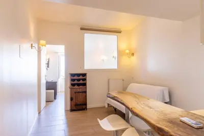 a room with a table and chairs and a window at Appartements Vivo in Cagnes-sur-Mer