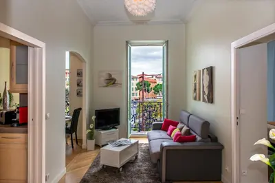 a living room with a couch and a tv at Aston - Appartement Centre Ville Massena in Nice