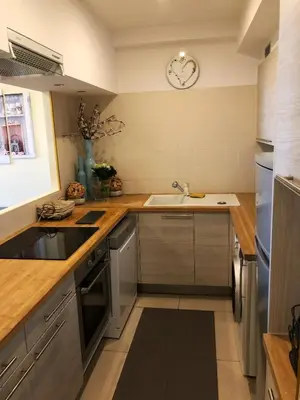 a kitchen with a sink and a clock on the wall at Aston - Appartement Centre Ville Massena in Nice