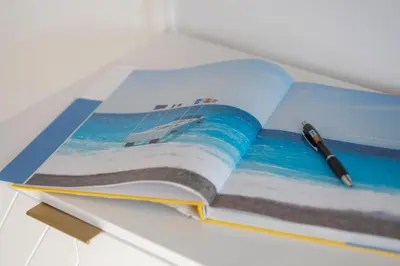 an open book with a pen on top of it at BLUE LIGHT TERRACE - Nice Port in Nice
