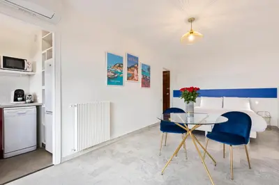 a room with a bed and a table and chairs at BLUE LIGHT TERRACE - Nice Port in Nice