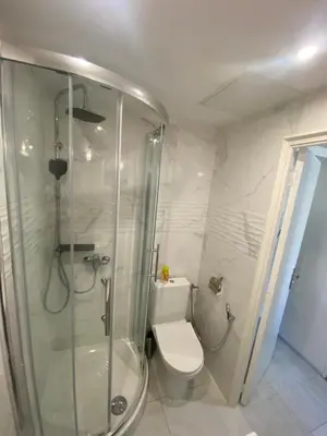 a bathroom with a toilet and a glass shower at Studio sur avenue jean médecin à Nice in Nice