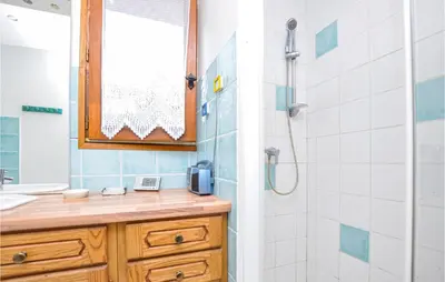 a bathroom with a sink and a shower with a counter at Nice Home In Saint-Jeannet in Saint-Jeannet
