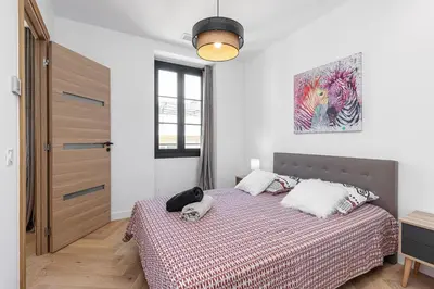 a bedroom with a bed and a painting on the wall at Magnifique appartement, Nice Centre Ville - Masséna in Nice