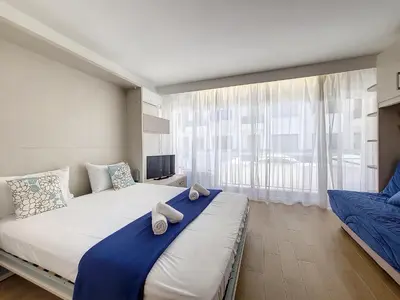a bedroom with a large bed with towels on it at Nestor&Jeeves - THAIS BEACH - Central - Very close sea - Pedestrian zone in Nice