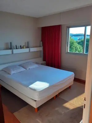 a bedroom with a large bed with a window at Maeva in Saint-Laurent-du-Var