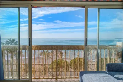 a view of the ocean from a living room window at Appartement Rivage - Welkeys in Cagnes-sur-Mer