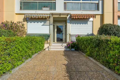 a house with a pathway leading to the front door at Appartement Rivage - Welkeys in Cagnes-sur-Mer