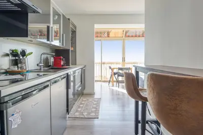 a kitchen with a sink and a counter top at Appartement Rivage - Welkeys in Cagnes-sur-Mer
