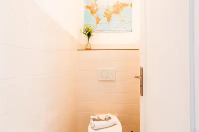 a bathroom with a toilet and a vase of flowers at Imperial AP4318 by Riviera Holiday Homes in Nice