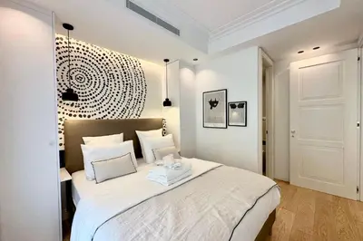 a bedroom with a large white bed with white pillows at OPERA PROMENADE 4 Renovated 3 Bedrooms Balcony Sea View AC in Nice