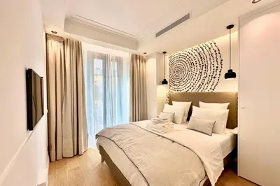 a bedroom with a bed and a large window at OPERA PROMENADE 4 Renovated 3 Bedrooms Balcony Sea View AC in Nice
