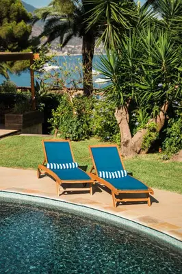 two lounge chairs sitting next to a swimming pool at Charming Villa Saint-Jean-Cap-Ferrat in Saint-Jean-Cap-Ferrat
