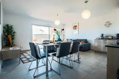 a kitchen and living room with a table and chairs at Blue Pearl A008 By Avecoeur in Nice
