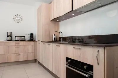 a kitchen with wooden cabinets and a stove top oven at Blue Pearl A008 By Avecoeur in Nice