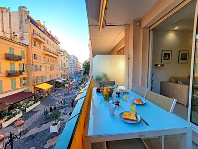 a blue table on a balcony with food on it at Nestor&Jeeves - ANGLICAN TERRASSE - Central - Very close sea in Nice