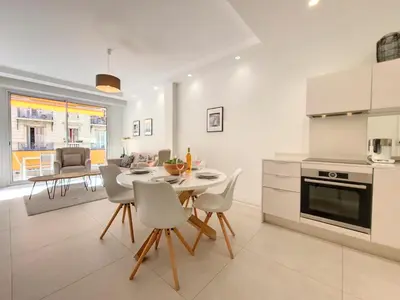 a kitchen and dining room with a table and chairs at Nestor&Jeeves - ANGLICAN TERRASSE - Central - Very close sea in Nice