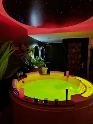 a bathroom with a sink and two round mirrors at La loveroom bdsm de Nice 