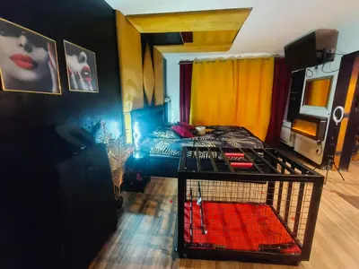 a hot tub in a room with pink lighting at La loveroom bdsm de Nice 