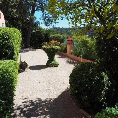 a garden with a vase with flowers in it at Villa la Felicite in Saint-Jean-Cap-Ferrat