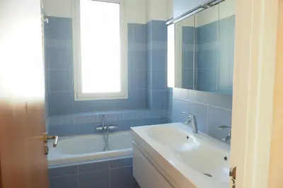 a bathroom with a sink and a tub and a window at Villa la Felicite in Saint-Jean-Cap-Ferrat