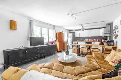 a living room with a couch and a table at Lovely townhouse in a lively area close to the old Nice in Nice
