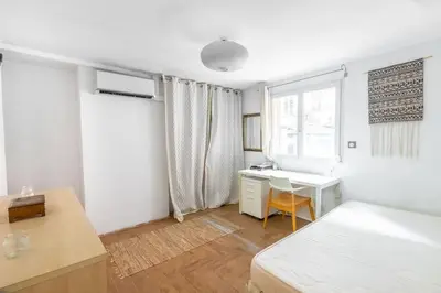 a bedroom with a bed and a desk and a window at Lovely townhouse in a lively area close to the old Nice in Nice