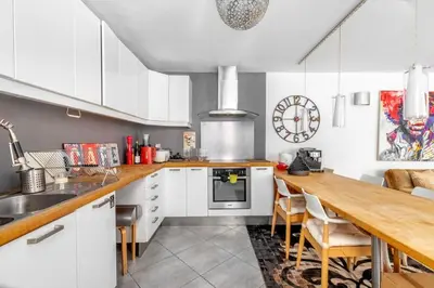 a kitchen with white cabinets and a wooden counter top at Lovely townhouse in a lively area close to the old Nice in Nice