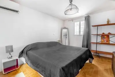 a bedroom with a bed with a black blanket at Lovely townhouse in a lively area close to the old Nice in Nice