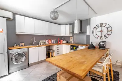 a kitchen with a wooden table and a sink at Lovely townhouse in a lively area close to the old Nice in Nice