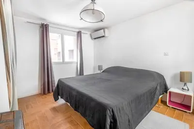 a white bedroom with a bed and a window at Lovely townhouse in a lively area close to the old Nice in Nice