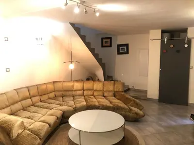 a living room with a couch and a table at Lovely townhouse in a lively area close to the old Nice in Nice