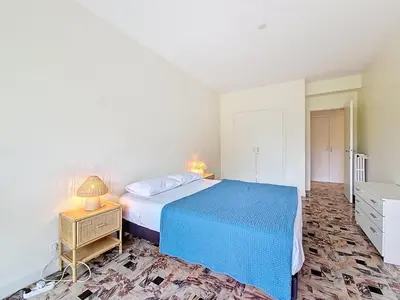 a bedroom with a bed and a table with a lamp at Nestor&Jeeves - SOLAR - By sea - Balcony in Nice
