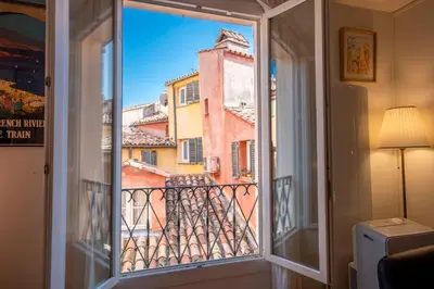 a window with a view of a building at Spacious and bright flat close to the beach : heart of old Nice in Nice