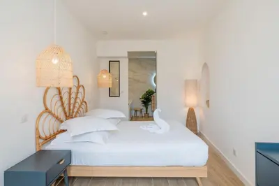 a bedroom with a white bed and a desk at A/C & BALNEO in of Carré d'Or NICE #RENOVATED in Nice
