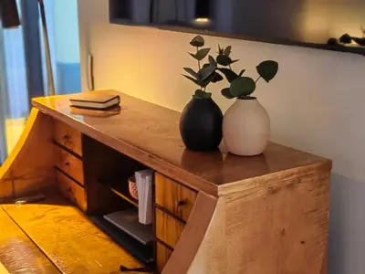 two vases sitting on top of a wooden dresser at Exceptional brand new flat, 20 m from beach, 85 sq in Nice