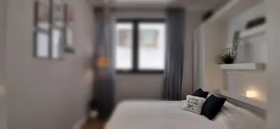 a bedroom with a bed with a pillow on it at Exceptional brand new flat, 20 m from beach, 85 sq in Nice