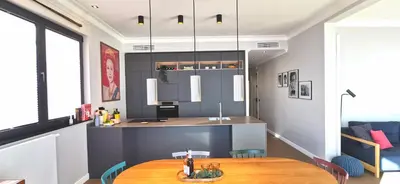a kitchen and dining room with a wooden table at Exceptional brand new flat, 20 m from beach, 85 sq in Nice